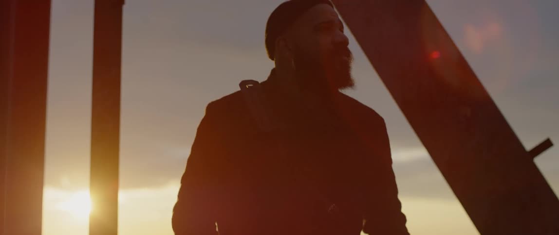 A man walking around at sunset
