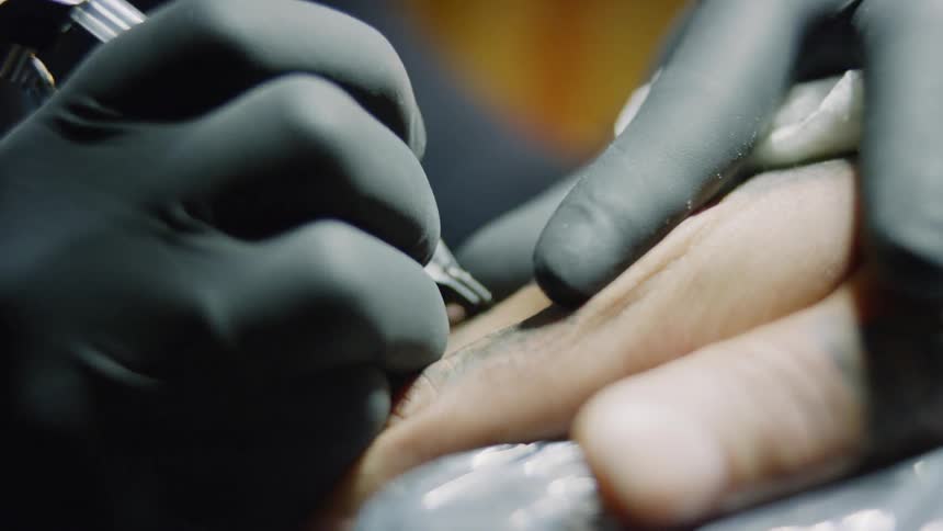 A hand being tattooed