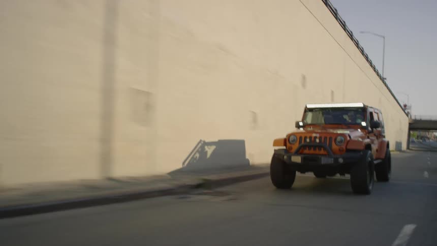 Person is driving jeep on freeway on sunny day