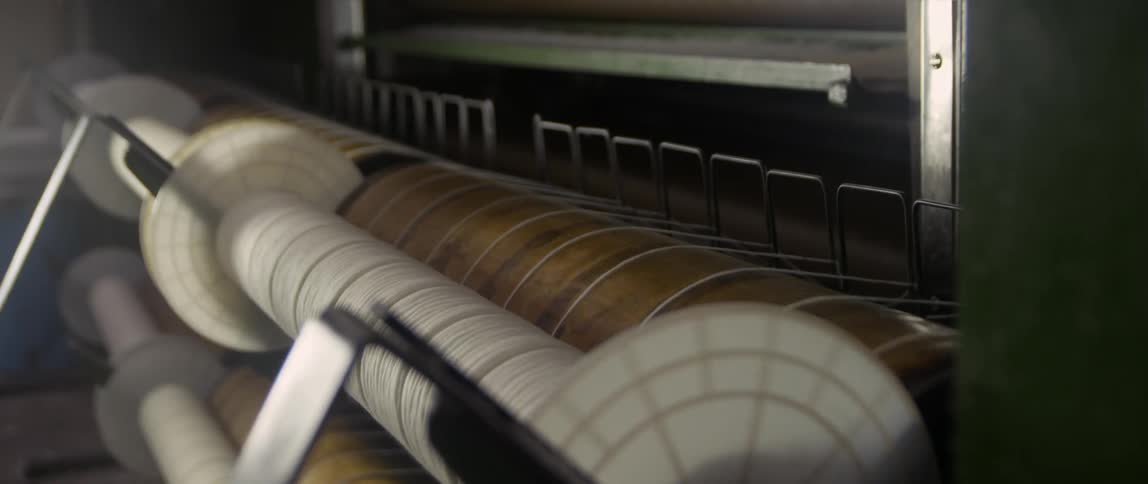 A machine rolling string spools