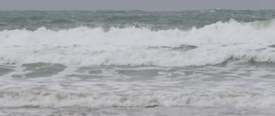 Waves crash as they approach the shoreline