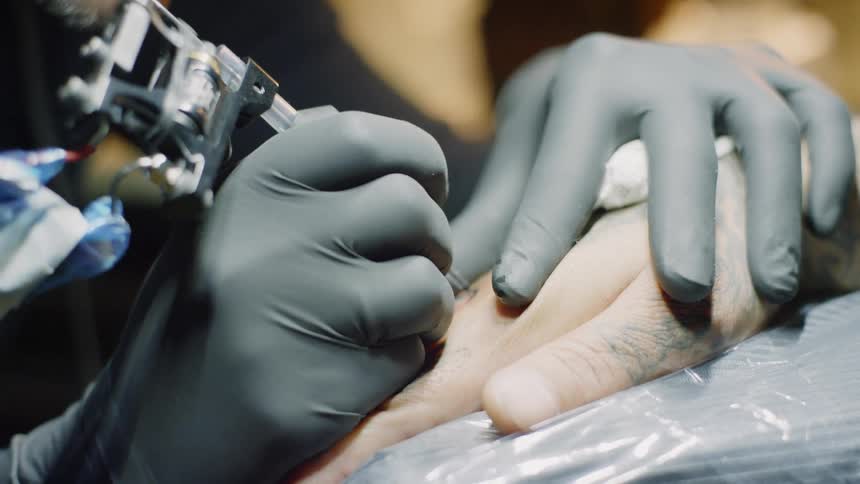 A hand being tattooed