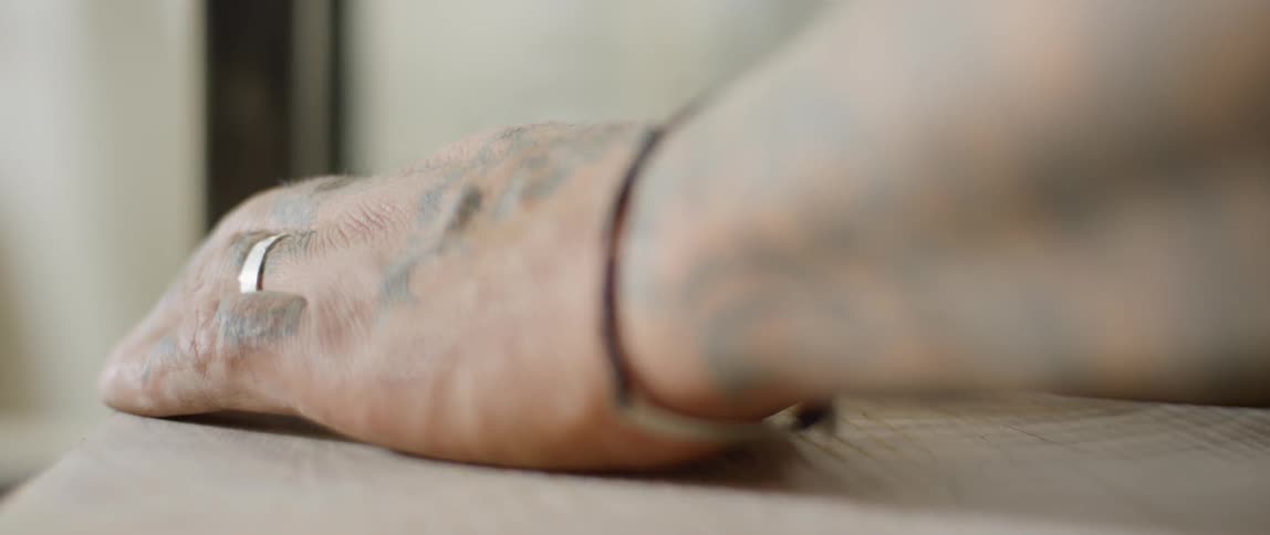 Hand smooths over a wooden surface