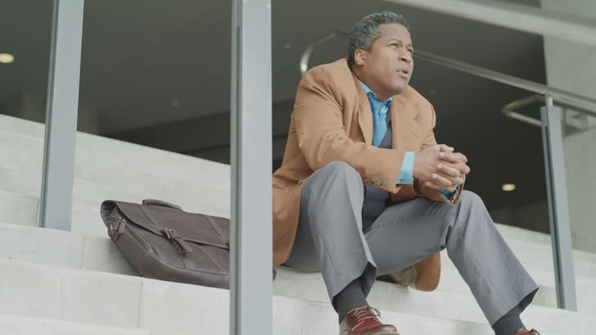 A man sitting on steps outside