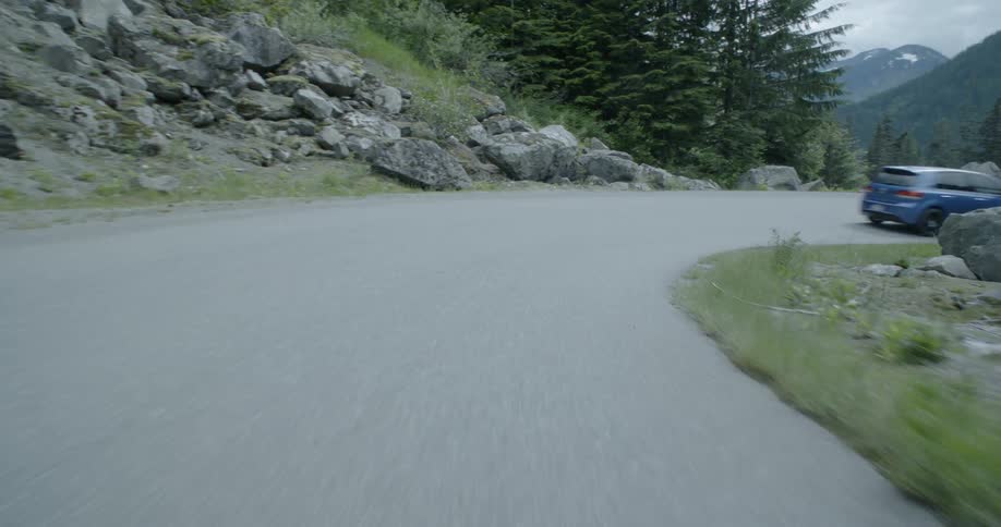 Car travels down a mountain road
