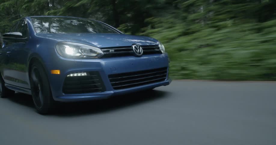 A car driving on the road in the forest