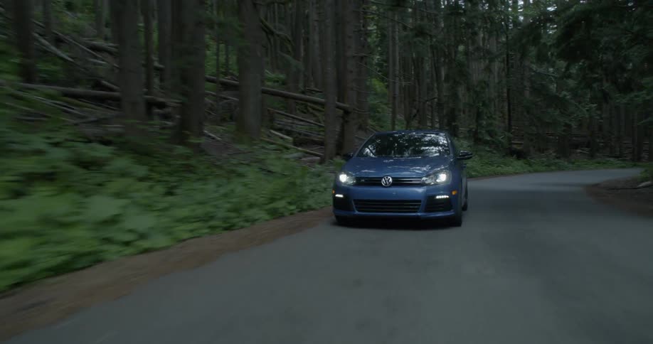 A car is driving on a road outside