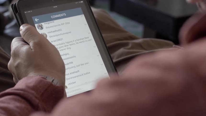 A person scrolls through text on their tablet