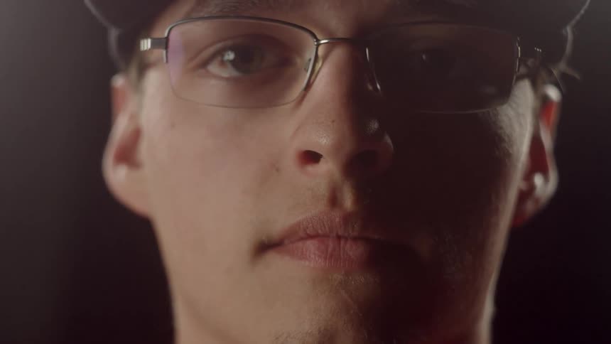 Man Putting On Glasses