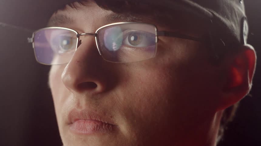 Man putting on glasses