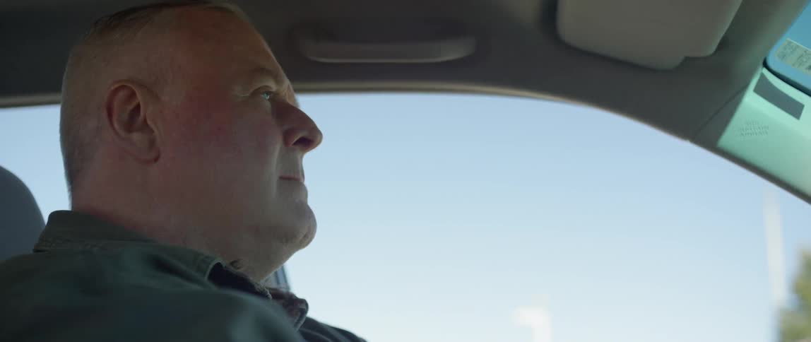 A man is driving in a car
