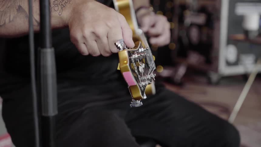 A man tunes his guitar