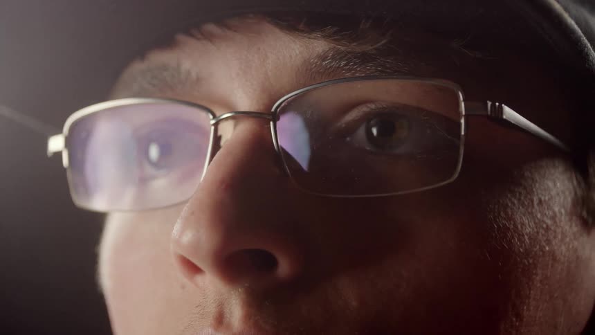 Man Putting On Glasses
