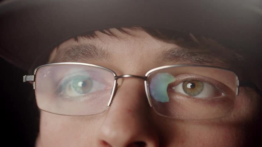 Close Up of eyes of man putting on glasses