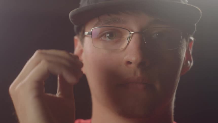 A man putting on his glasses