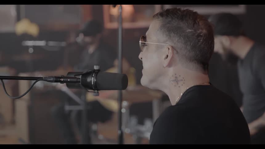 A band sings and performs on stage