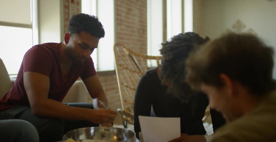 People write and talk together in the living room