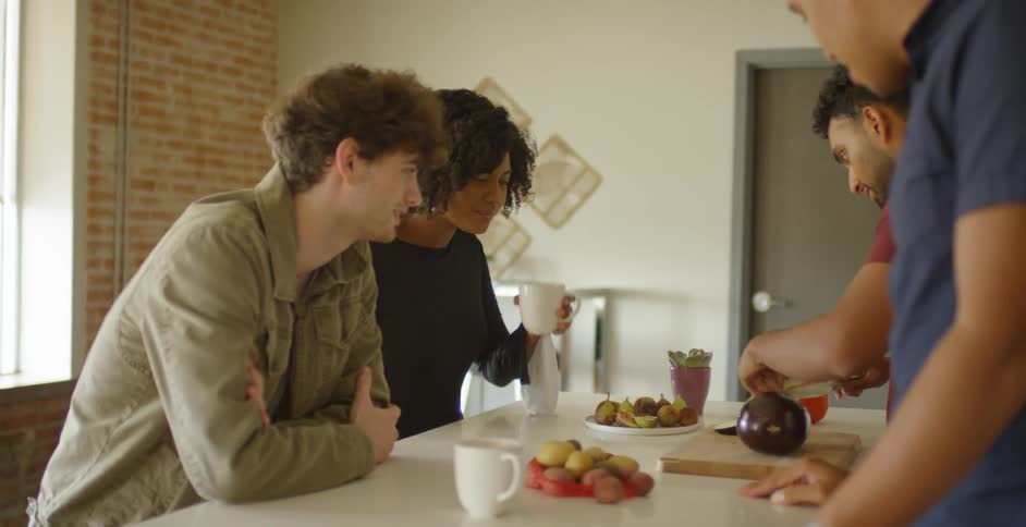 Friends drink coffee and eat food in a loft