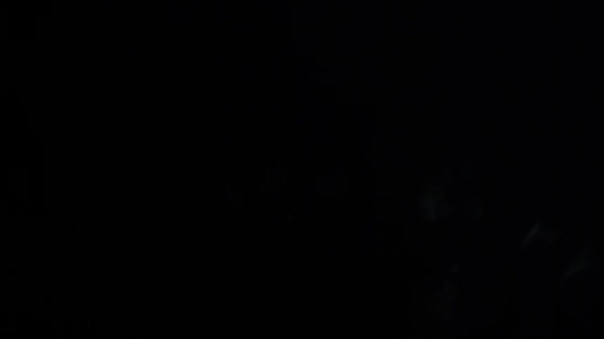 The light is flickering on the dark rocks