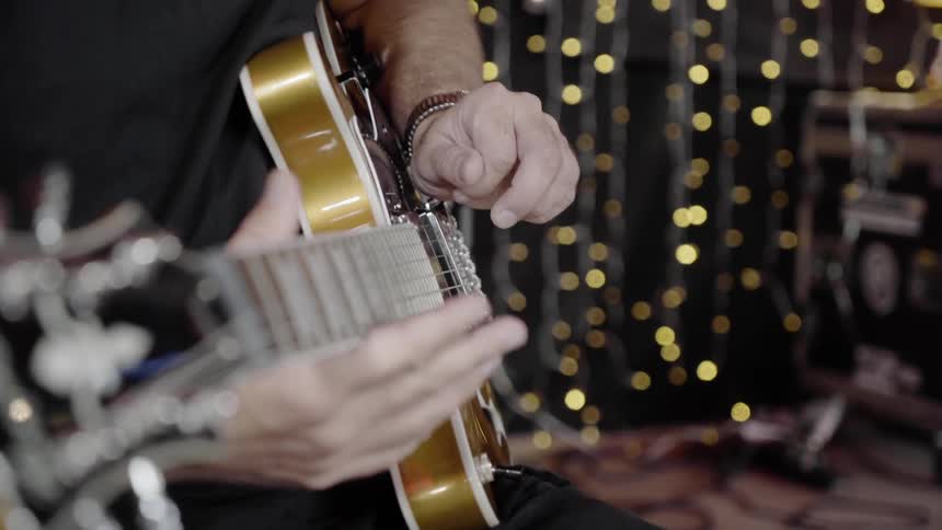 A man tunes a guitar