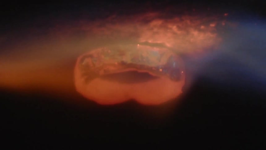 A blue flame on a very bright red hot piece of metal