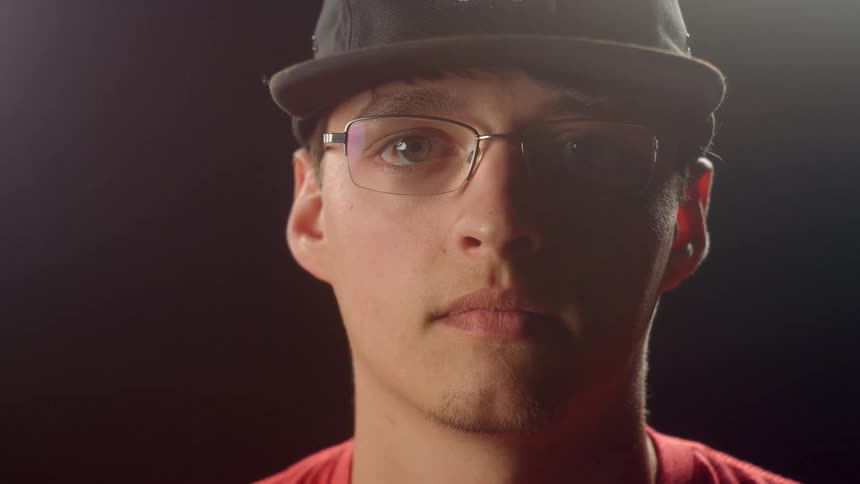 Man Putting On Glasses