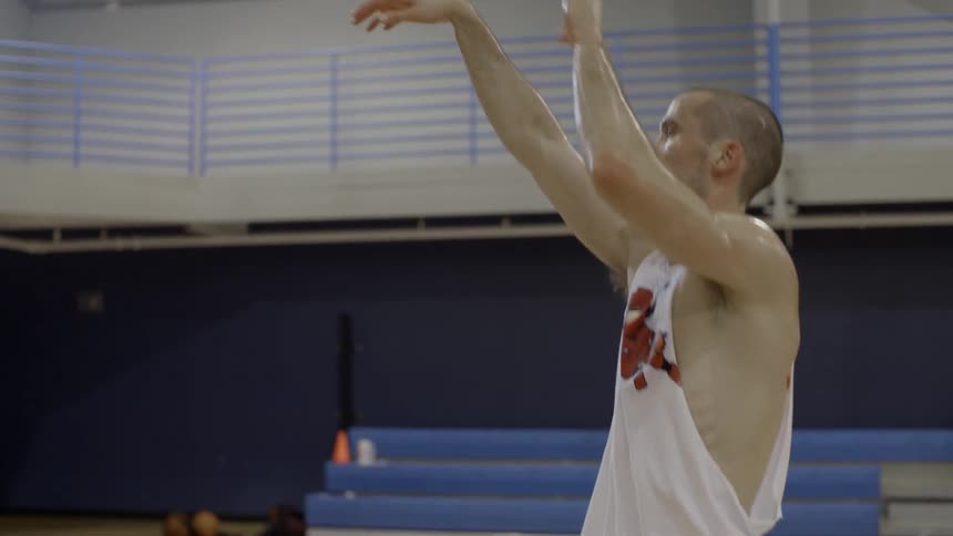 A person shooting a baketball