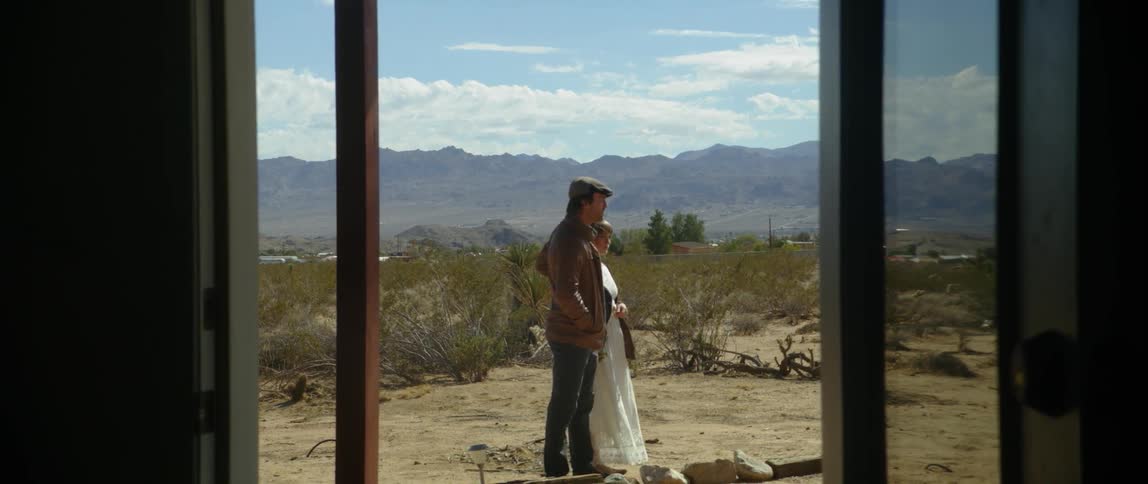 A man and a woman standing outside