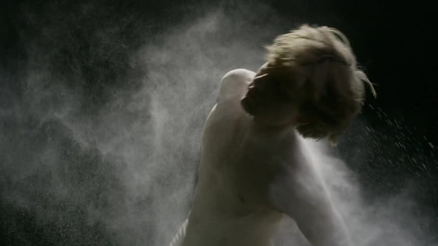 Man dancing around while flour is being thrown