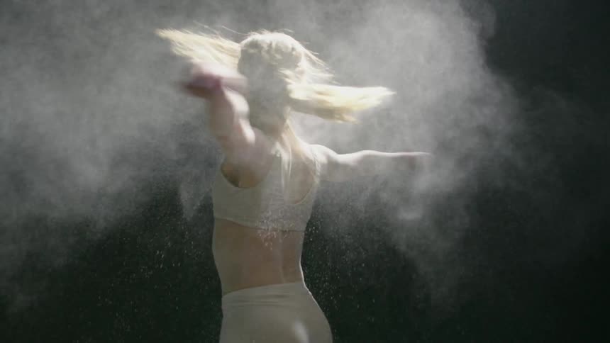 Dust floats in the air around a spinning dancer