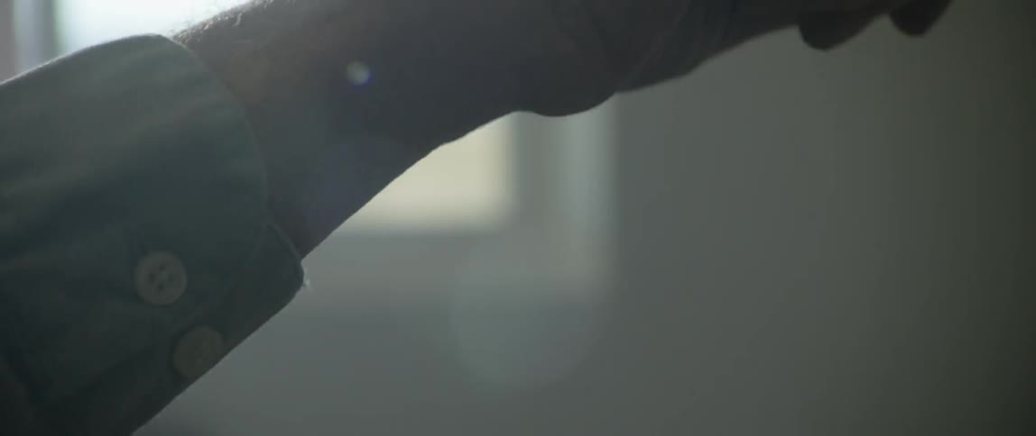 A person makes long strokes as the paint is applied