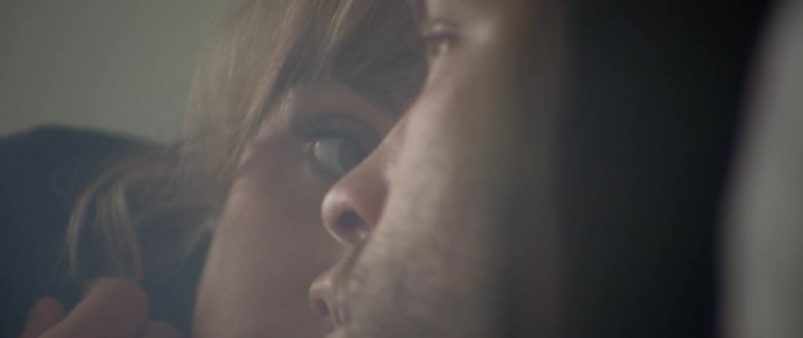 A man and woman cuddle