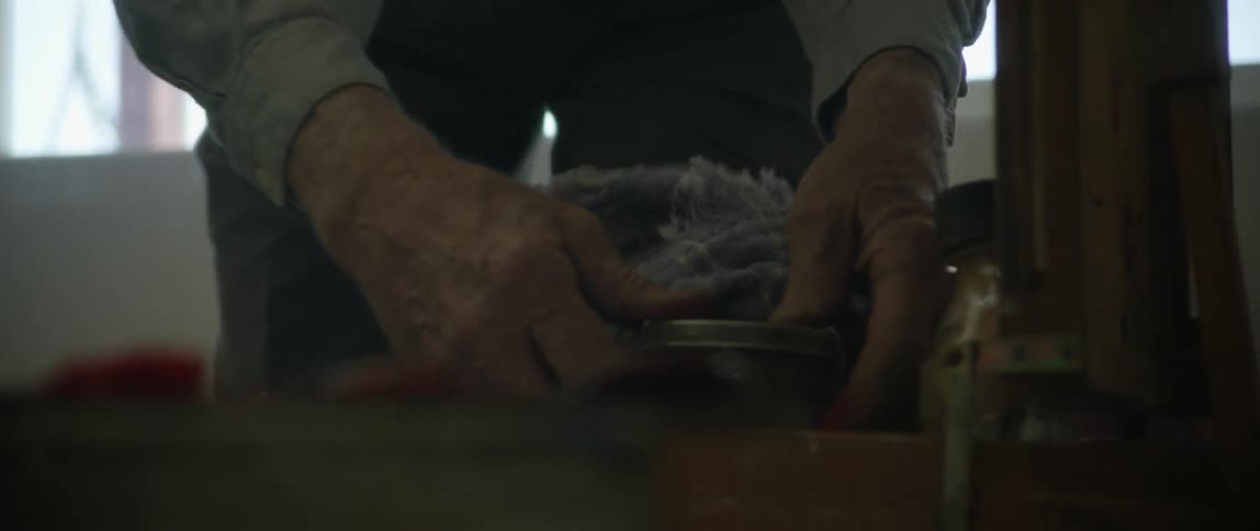A man packs up cans and removes lids