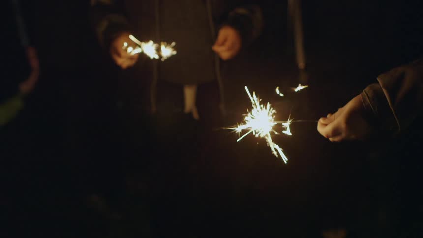 People are holding sparklers