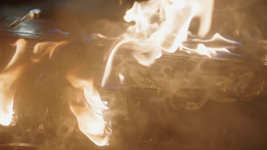 The vehicle is on fire at night