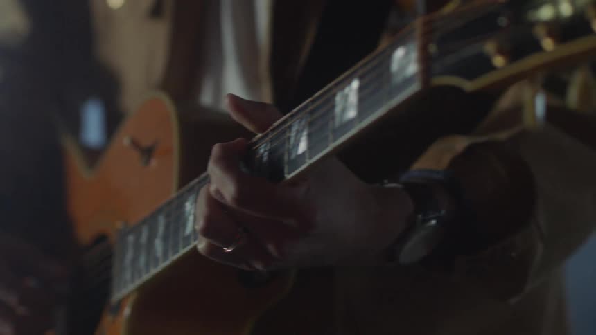 A man plays an acoustic guitar