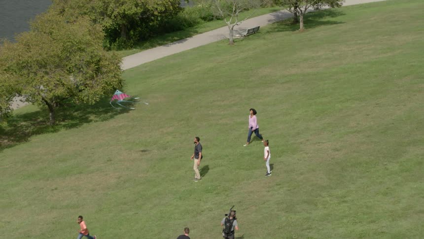 People flying a kite in a park