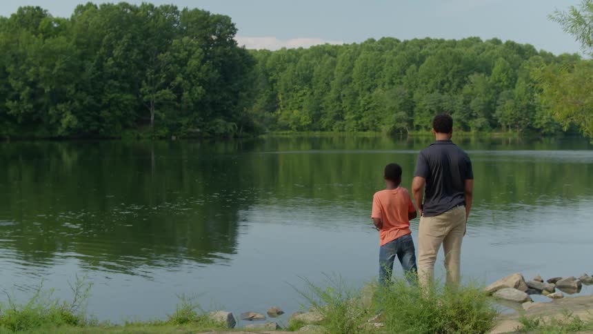 Two men fish in the water