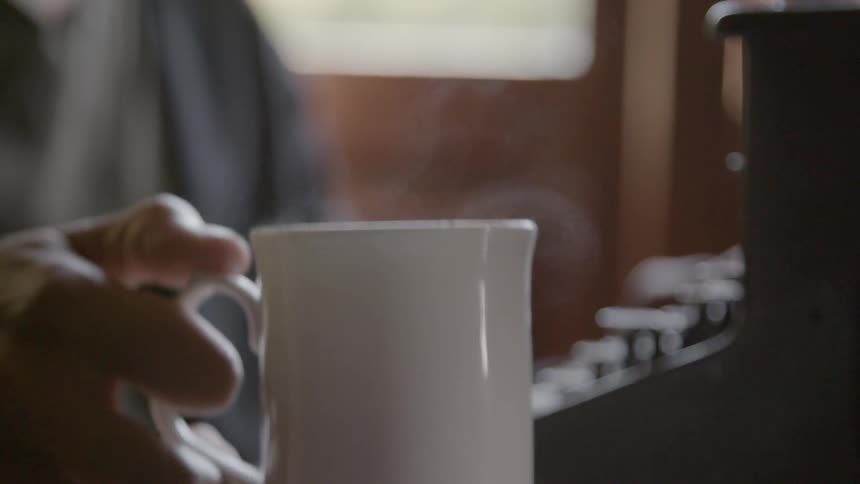 A person is making a cup of coffee