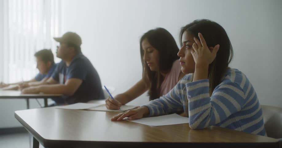 Students at a table taking notes