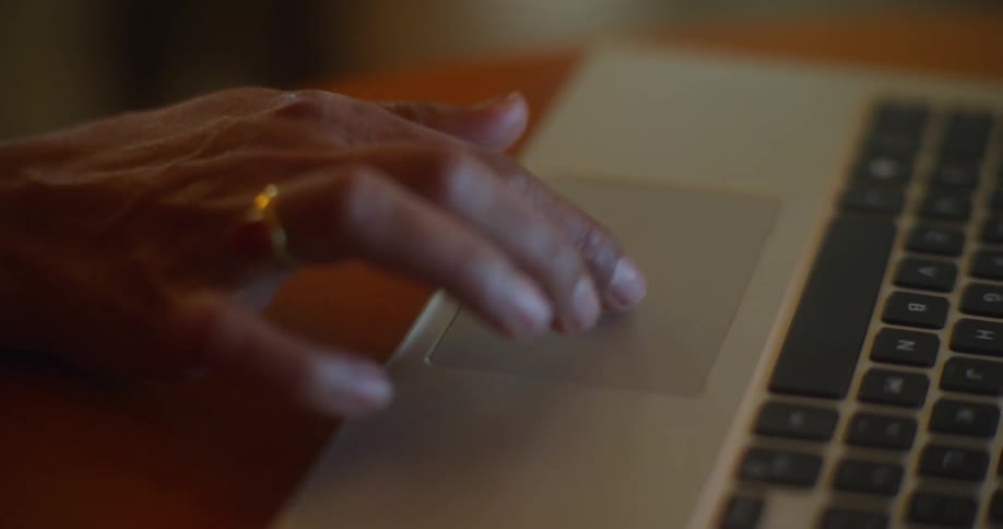 A person is using the mouse pad on their laptop
