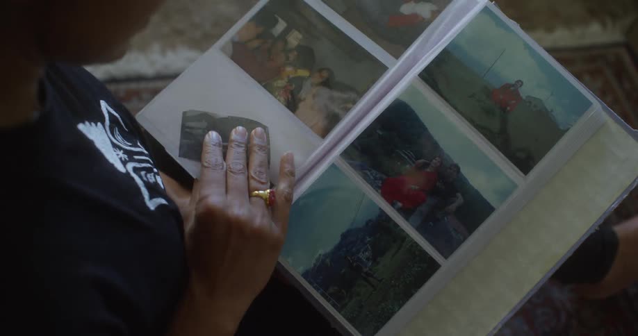 A woman is looking through some photographs