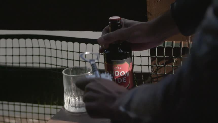A person grabbing a beer