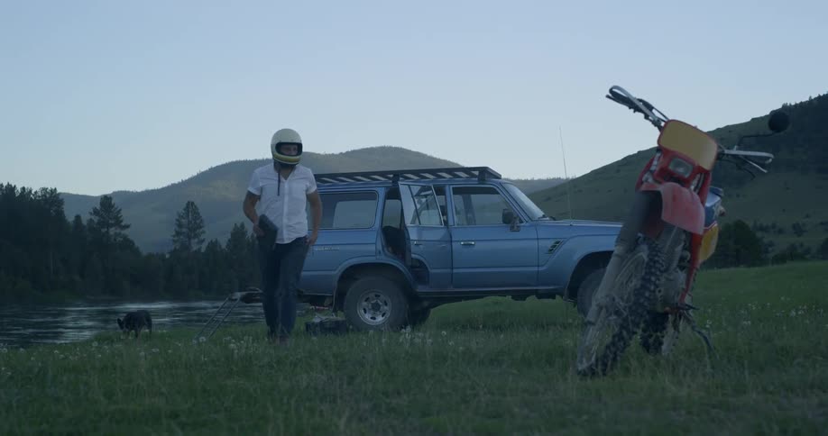 A man grabbing tools in a jeep