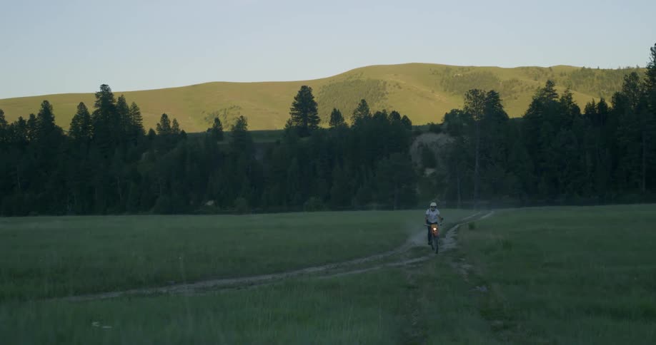 A motorcycle driving on a path in a field