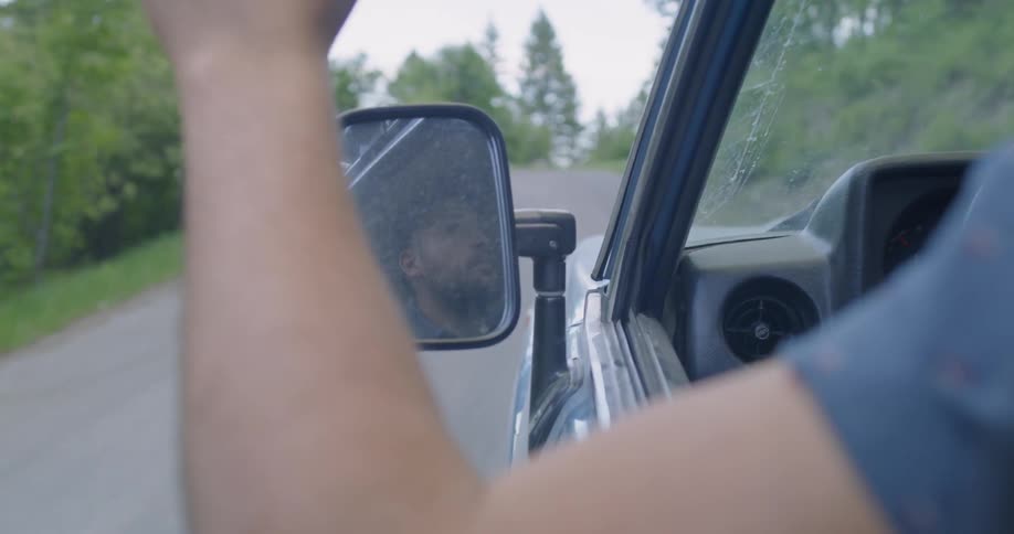 A man drives on a forest road