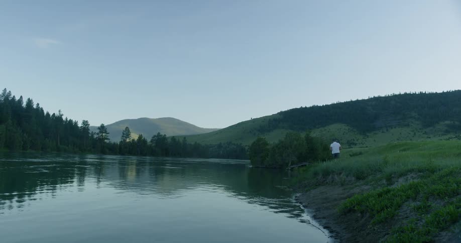 A person is walking by a lake