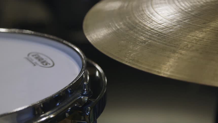 A close up view of a drum snare and cymbal