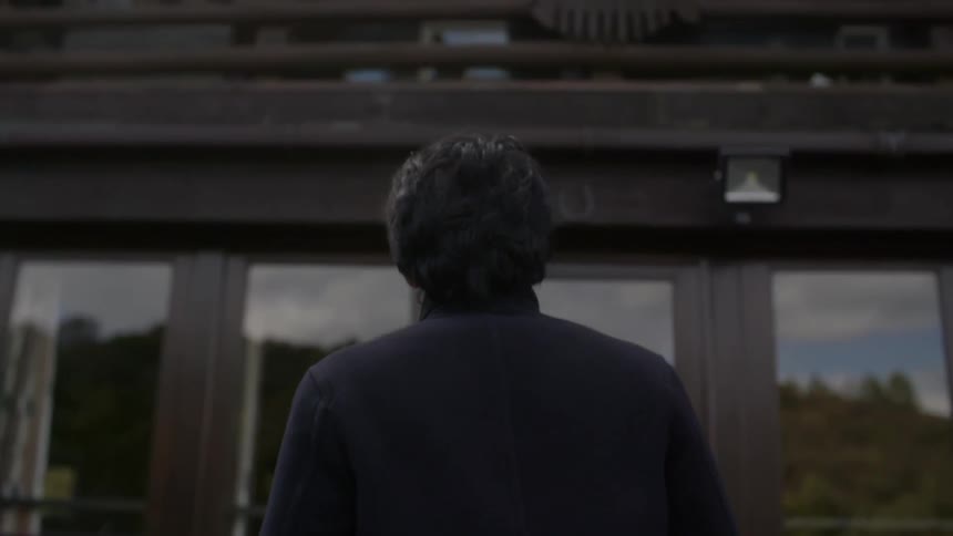 A person walking towards a building