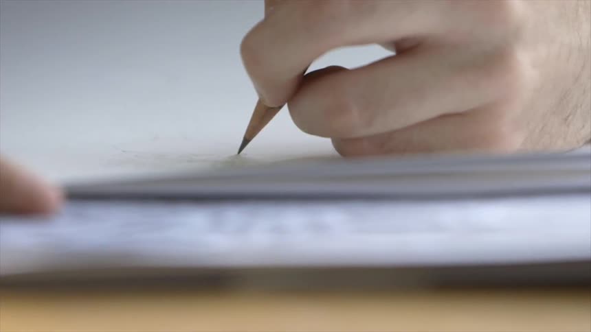 A person writing on paper
